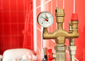 Part of solid fuel boiler with pressure gauge, close up