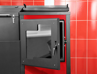 Solid fuel boiler against red wall