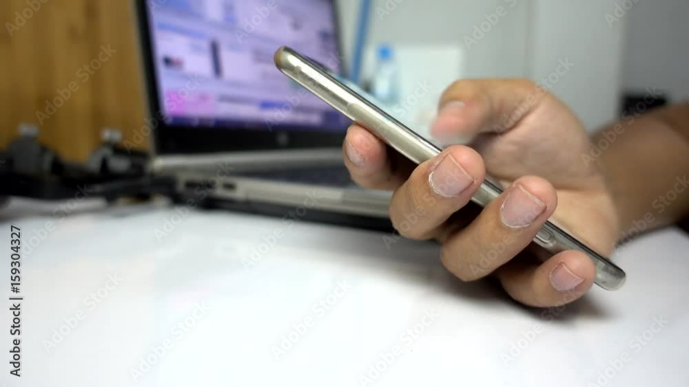 Poster Man using smartphone on work table- Closeup