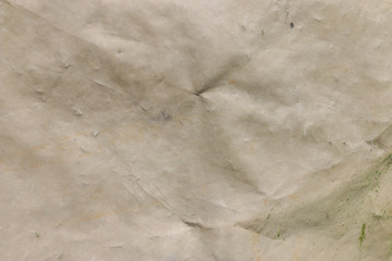 Warm grey color plastic tarpaulin covering, polyester fabric texture.