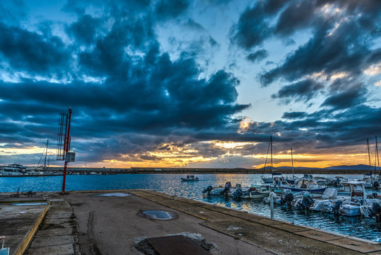Dark clouds over Alghero harbor at sunset
