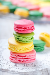 Colorful tasty macaroons on napkin, natural light selective focus. Sweet and colorful dessert close up