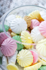 Colorful meringue cookies on napkin, natural light selective focus