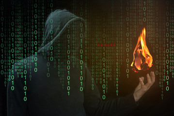 Hacker show a fireball on his hand with green digital binary in foreground. Fireball Adware Infects...