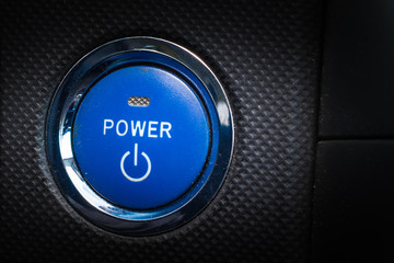 Hybrid car blue start engine button.