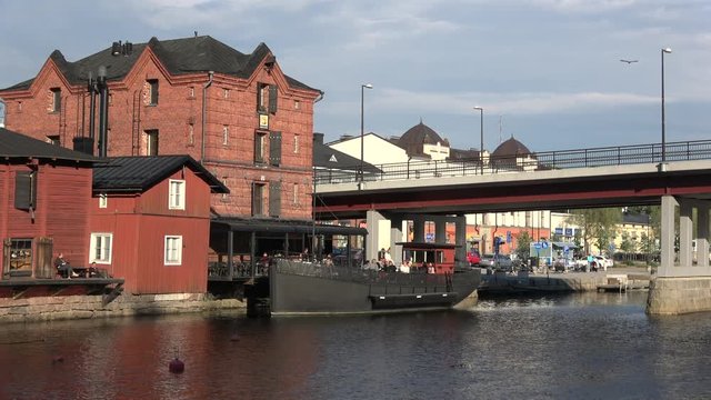 Summer dining on the deck of an old barge on the river Porvoonjoki. Old Porvoo, Finland