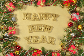 Happy New Year golden text and spruce branch and Christmas decorations