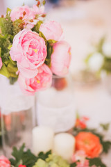 beautiful pink peonies in clear vase on the delicate bright background texture abstraction copyspace close-up