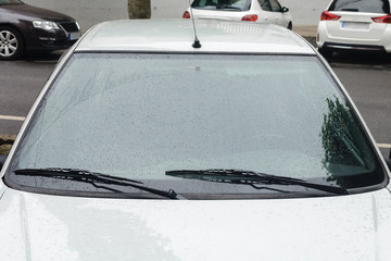 view of the car windshield wipers in the rain