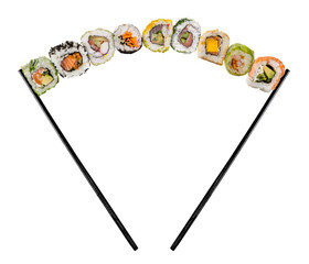 Sushi pieces placed between chopsticks, separated on colored background. Popular sushi food.