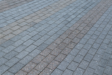 Area or walkway made of granite or marble rectangular tiles grey and brown.