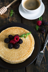 Thin pancakes with fresh berries and coffee
