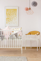 Poster over cozy nursery crib
