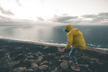 Man climbing the Rocks high above Cofete Beach - Fuerteventura