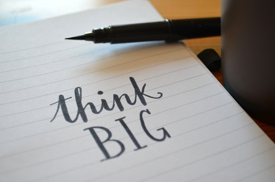 THINK BIG motivational quote written in notebook