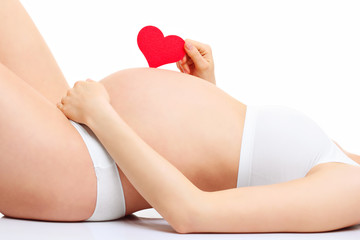Pregnant woman with hearts over white background