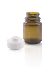 Empty brown glass jar and plastic cover