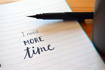 I NEED MORE TIME hand lettered in notebook