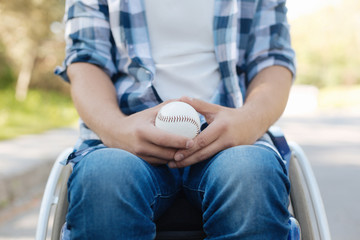 Close up of baseball ball being in male hands