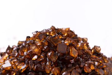 Heap of brown Amber stones on white background