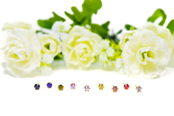 Gold pendant cameo jewelry and colorful gemstones with flowers isolated on white