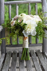 Peachy pinks, white, and green bridal bouquet with Juliet garden roses, O’Hara garden roses, gerondo gerbera daisies, rice flower, privet berries, Jasmine vine