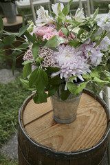 Peachy pinks, white, and green wedding flowers with Juliet garden roses, O’Hara garden roses, gerondo gerbera daisies, rice flower, privet berries, Jasmine vine