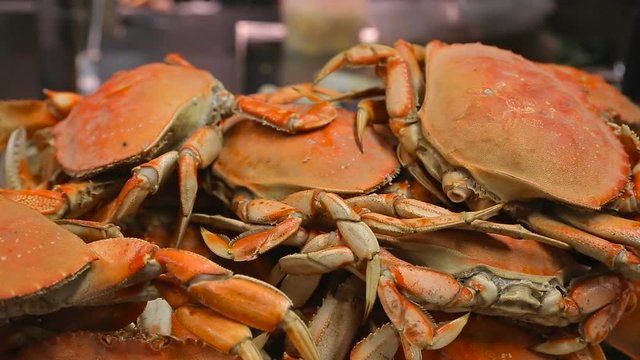 Crabs are cooked in the market in San Francisco. Appetizing freshly prepared crabs close-up.Street food cooking crabs to order. Cooked crabs lie on the front window in the foreground.