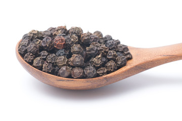Close up peppercorns in wooden spoon isolated on white background