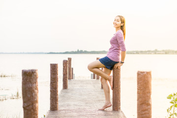 young girl on a wooden bridge