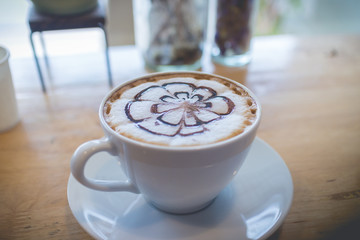 hot coffee with foam milk art in afternoon break