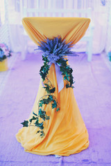 branch of an ivy and violet lilies on yellow wedding a lectern