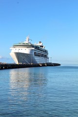 Obraz na płótnie Canvas Cruise ship docked on a beautiful blue ocean