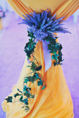 branch of an ivy and violet lilies on yellow wedding a lectern