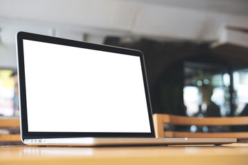 Mockup image of laptop with blank white screen on wooden table in coffee shop