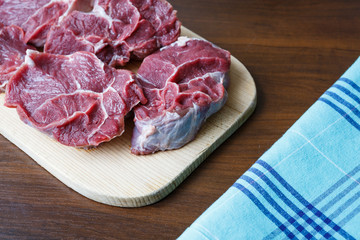 Fresh raw beef on wooden cutting plate