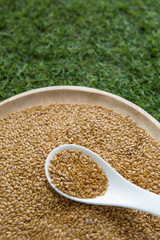 brown rice in wooden bowl on glass background