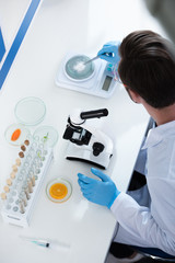 Fototapeta premium Male scientist during work at modern biological laboratory