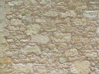Ancient stone wall texture. Rough old bricks background.