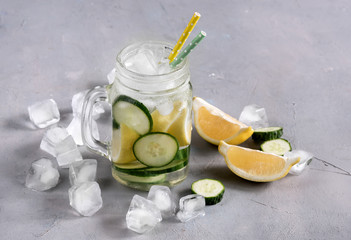 Delicious infused water with cucumber, lemon in glass bottle for fat flush detox.