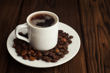 Coffee cup and coffee beans on wooden table
