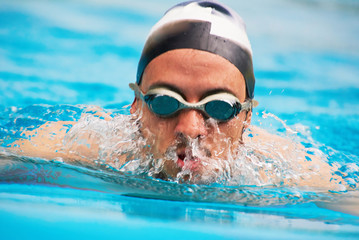 Swimmer man in water splashes