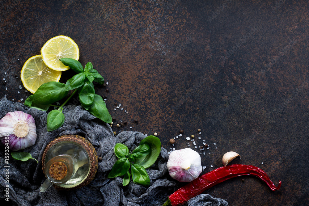 Wall mural ingredients for cooking - garlic, lemon, basil, spices and olive oil. food background on the kitchen