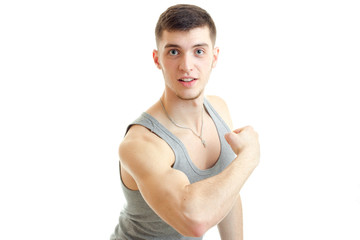 sporty young guy posing in the Studio and shows his muscles isolated on a white background