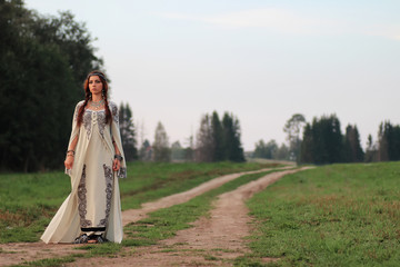 girl in long dress road country