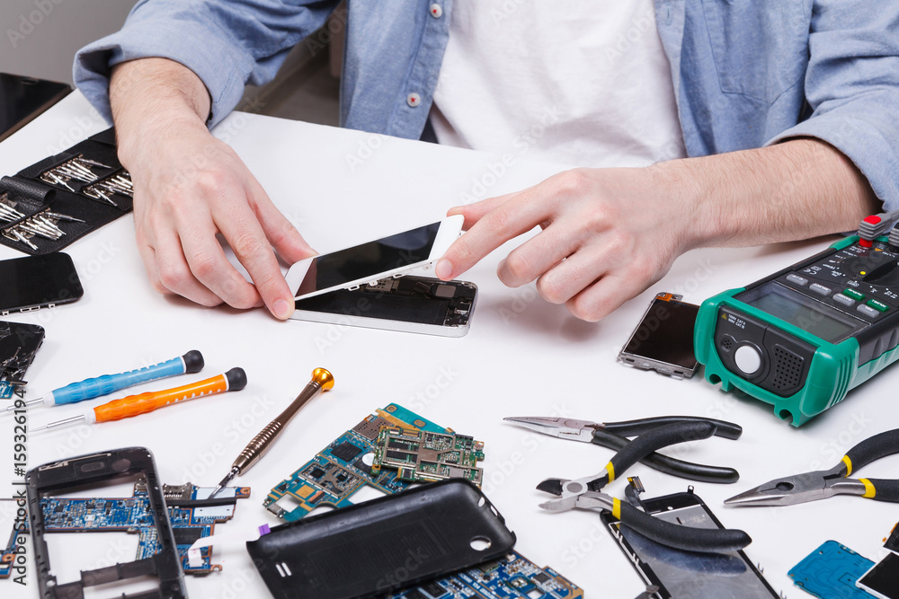 Poster repairman disassembling phone for inspecting