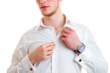 a close-up portrait of the young guy with the clock on his arm that adjusts his white shirt