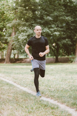 Man running jogging outdoors in park nature