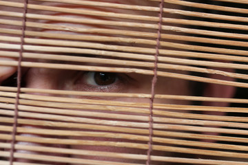 eyes looking through the blinds