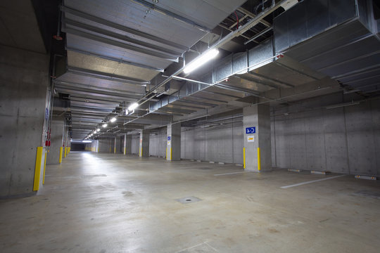 Parking garage underground interior, neon lights at night..